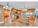 Island kitchen with wood cabinets and tiled floors at 4147 Boggy Creek Rd, Kissimmee, FL 34744
