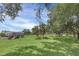 Large grassy backyard with shed and mature trees at 4147 Boggy Creek Rd, Kissimmee, FL 34744