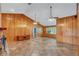 Spacious living room with wood paneled walls and tile floors at 4147 Boggy Creek Rd, Kissimmee, FL 34744