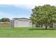 Detached garage with large roll-up door in backyard at 4147 Boggy Creek Rd, Kissimmee, FL 34744