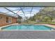 Relaxing screened-in pool area with fountain and brick pavers at 4147 Boggy Creek Rd, Kissimmee, FL 34744