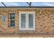 French doors leading to the pool area from the brick exterior at 4147 Boggy Creek Rd, Kissimmee, FL 34744