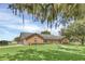 Brick ranch house with mature landscaping and large tree at 4147 Boggy Creek Rd, Kissimmee, FL 34744