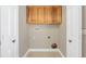 Laundry area with wood cabinets and overhead storage at 4147 Boggy Creek Rd, Kissimmee, FL 34744
