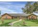 Brick ranch house with a walkway and landscaping at 4147 Boggy Creek Rd, Kissimmee, FL 34744