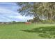 Open field with grass and distant buildings at 4147 Boggy Creek Rd, Kissimmee, FL 34744