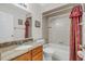 Bathroom with granite countertop, tub shower combo, and updated vanity at 4147 Boggy Creek Rd, Kissimmee, FL 34744