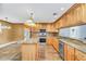 Eat-in kitchen with granite countertops and stainless steel appliances at 4147 Boggy Creek Rd, Kissimmee, FL 34744