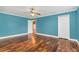 Bedroom with hardwood floors and teal walls at 4147 Boggy Creek Rd, Kissimmee, FL 34744
