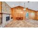 Spacious living room featuring a brick fireplace and wood paneling at 4147 Boggy Creek Rd, Kissimmee, FL 34744