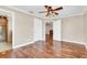 Hardwood floors, ceiling fan, and neutral walls in this bright bedroom at 4147 Boggy Creek Rd, Kissimmee, FL 34744