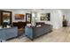Open concept living room with brown couches and a large TV at 280 Pendant Ct, Kissimmee, FL 34747