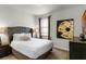 Primary bedroom with plush bed and large-scale art at 280 Pendant Ct, Kissimmee, FL 34747