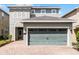 Two-story house with a two-car garage and a landscaped front yard at 280 Pendant Ct, Kissimmee, FL 34747