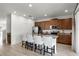 Modern kitchen with brown cabinets, granite countertop, and island seating at 280 Pendant Ct, Kissimmee, FL 34747