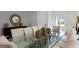 Glass-top dining table with white chairs and gold accents at 280 Pendant Ct, Kissimmee, FL 34747