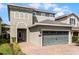 Two-story house with a two-car garage and landscaped front yard at 280 Pendant Ct, Kissimmee, FL 34747