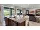 Open concept kitchen and living area with granite island and modern furniture at 280 Pendant Ct, Kissimmee, FL 34747