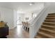 Beige carpeted staircase with white handrail and open concept view at 280 Pendant Ct, Kissimmee, FL 34747
