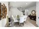 Modern glass dining table with white chairs in an open floor plan at 280 Pendant Ct, Kissimmee, FL 34747
