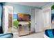 bedroom with beach-themed mural, TV, and access to bathroom at 280 Pendant Ct, Kissimmee, FL 34747