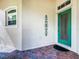 Inviting teal front door with a glass insert and brick walkway at 722 Coronado Dr, Kissimmee, FL 34759