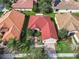 Aerial view of single-Gathering home with red tile roof, landscaped yard, and paved driveway at 722 Coronado Dr, Kissimmee, FL 34759