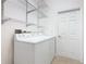 Laundry room with washer, dryer and ample shelving at 722 Coronado Dr, Kissimmee, FL 34759