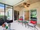 Relaxing screened patio with seating area, ceiling fan, and views of the backyard at 722 Coronado Dr, Kissimmee, FL 34759