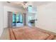 Living room with tile flooring, a ceiling fan, and access to a screened patio at 722 Coronado Dr, Kissimmee, FL 34759
