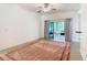 Living room with tile floor, ceiling fan and access to screened patio at 722 Coronado Dr, Kissimmee, FL 34759