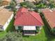 Top-down view of home showcasing red tile roof and screened patio at 722 Coronado Dr, Kissimmee, FL 34759