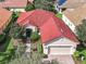 House with red tile roof, landscaping, and a 2-car garage at 722 Coronado Dr, Kissimmee, FL 34759