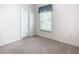 Well-lit bedroom featuring neutral walls and carpet at 722 Coronado Dr, Kissimmee, FL 34759