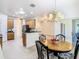 Kitchen features wood cabinets, and a dining area with a round table at 722 Coronado Dr, Kissimmee, FL 34759