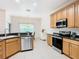 Modern kitchen with stainless steel appliances and wood cabinets at 722 Coronado Dr, Kissimmee, FL 34759