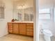 Bathroom with double sinks, large mirror and toilet at 722 Coronado Dr, Kissimmee, FL 34759