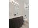 Bathroom with a quartz top vanity and updated lighting at 7166 Oak Glen Trl, Harmony, FL 34773