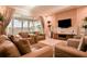 Living room with large TV and access to patio at 3213 Brasilia Ave, Kissimmee, FL 34747