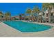 Resort-style pool with lounge chairs and palm trees at 3213 Brasilia Ave, Kissimmee, FL 34747