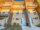 Modern three-story townhome with light-colored exterior and balcony at 3213 Brasilia Ave, Kissimmee, FL 34747