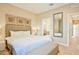 Spacious bedroom with plush bedding and an ensuite bathroom at 3213 Brasilia Ave, Kissimmee, FL 34747