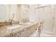 Double vanity bathroom with granite countertop and large shower at 3213 Brasilia Ave, Kissimmee, FL 34747