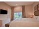 King-size bed, balcony access, and garden view at 3213 Brasilia Ave, Kissimmee, FL 34747
