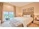 King-size bed, balcony access, and view of a garden at 3213 Brasilia Ave, Kissimmee, FL 34747