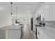 Modern kitchen with island, stainless steel appliances, and white cabinets at 2396 Sw 147Th Lane Rd, Ocala, FL 34473