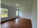 Spacious bedroom with wood flooring and large windows at 1204 Vero Beach Way, Poinciana, FL 34759