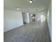 Open floor plan living area with kitchen, tile floors, and neutral colors at 1204 Vero Beach Way, Poinciana, FL 34759