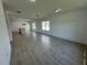 Open concept living room and kitchen with tile floors and lots of natural light at 1204 Vero Beach Way, Poinciana, FL 34759