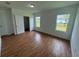 Bright bedroom with wood-look flooring, double closets and large windows at 1204 Vero Beach Way, Poinciana, FL 34759